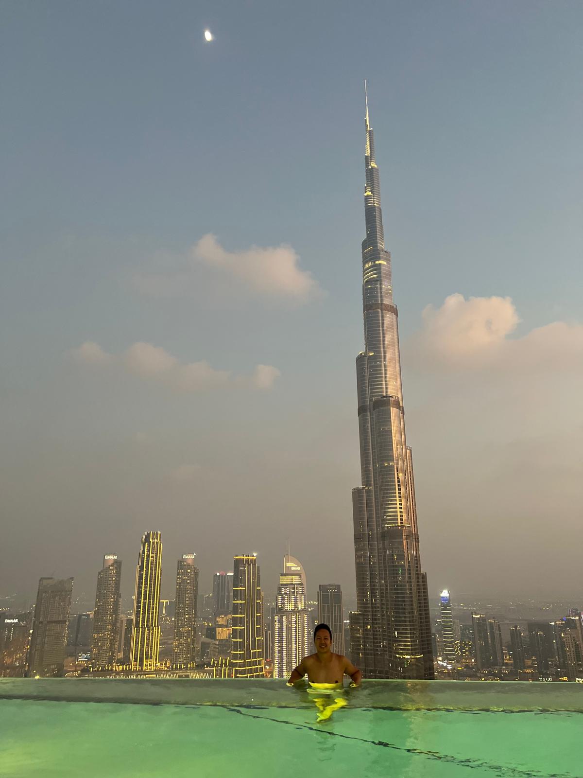 Christian in an infinity pool facing the Burj Khalifa in Dubai